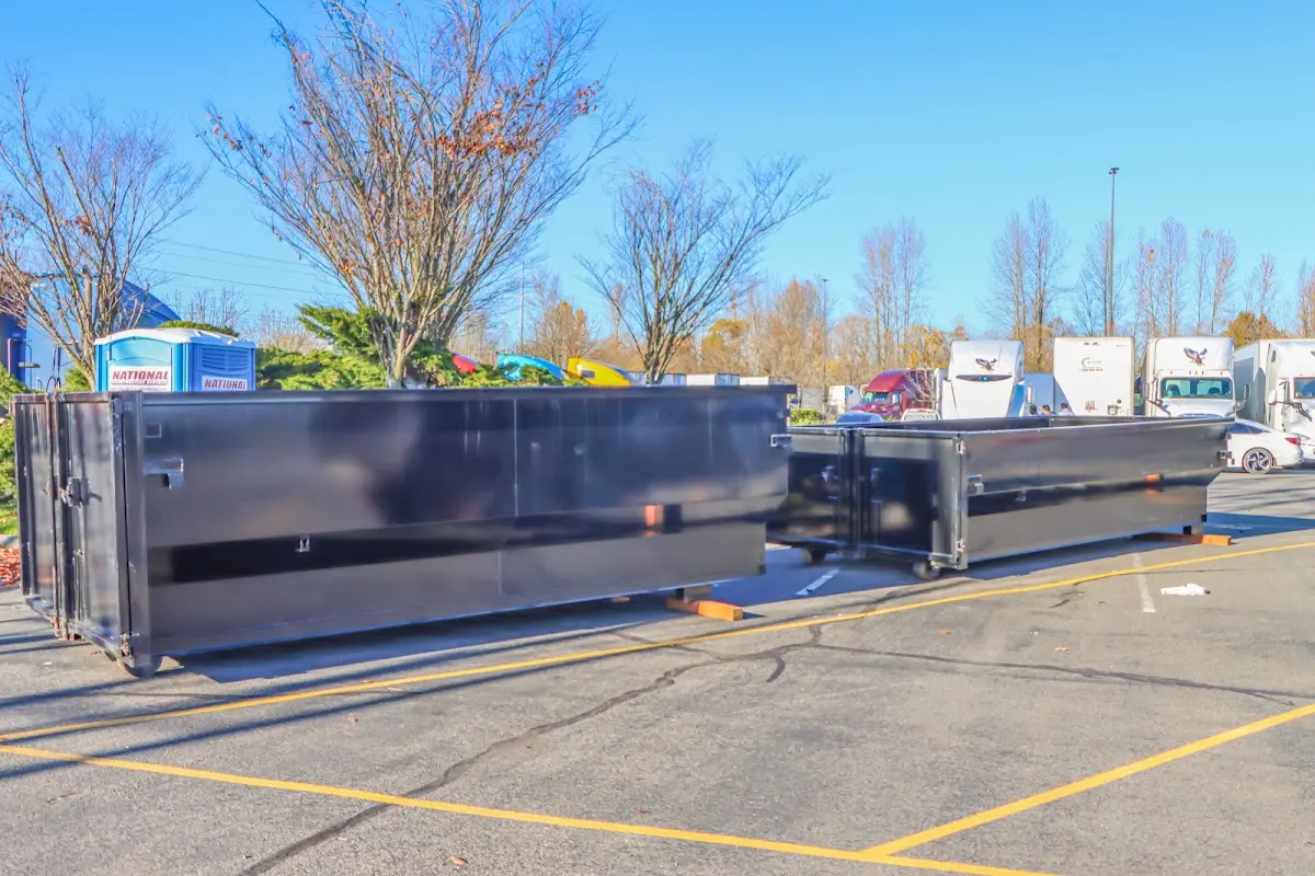 Professional dumpster rental service with roll-off container on residential driveway in Seymour